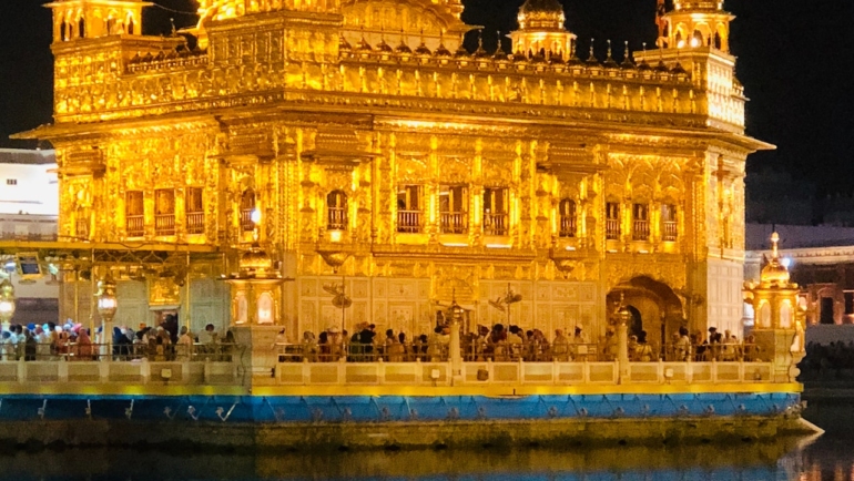 Golden Temple, a radiant and serene religious shrine reflecting in a tranquil pool of water.