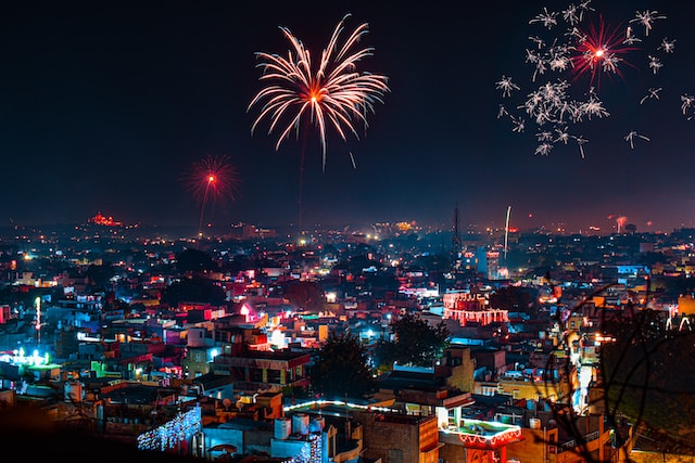 An image depicting a vibrant Diwali celebration with illuminated lamps, colorful rangoli, and joyful people.