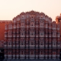 A stunning view of Jaipur's Hawa Mahal, also known as the Palace of Winds, showcasing its intricate pink sandstone architecture and numerous small windows.