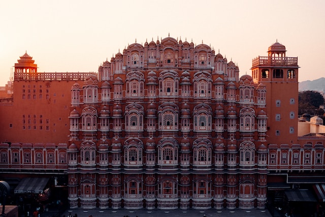 A stunning view of Jaipur's Hawa Mahal, also known as the Palace of Winds, showcasing its intricate pink sandstone architecture and numerous small windows.