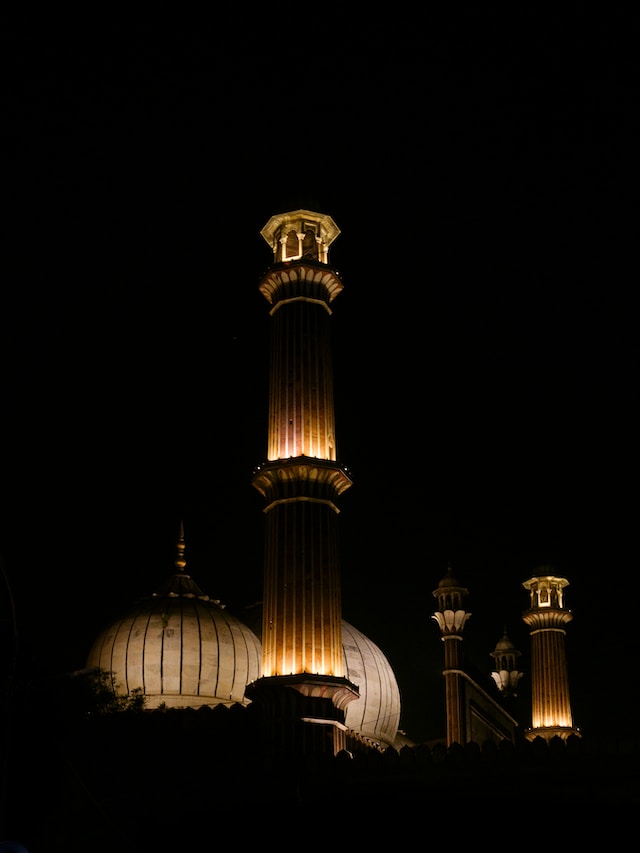 A serene Eid image featuring a beautifully decorated mosque, with worshippers in traditional attire.