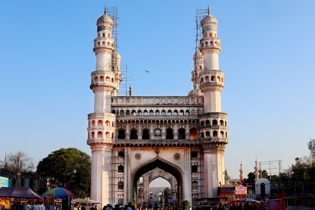 Charminar is a historic monument in Hyderabad, India, with its iconic four minarets rising against a blue sky.