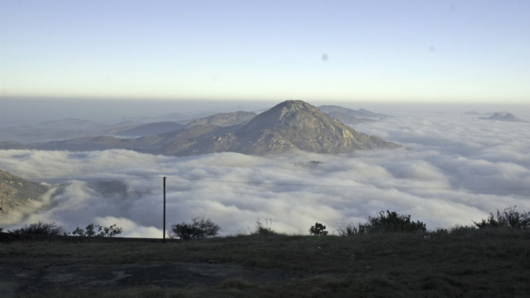 A captivating view of Nandi Hills in Karnataka, showcasing its serene beauty and lush landscapes, making it a tranquil gem for tourists to explore.