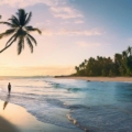Scenic coastal view with a serene beach and vibrant sunset reflecting on the water.