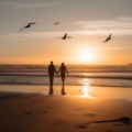 Couples Retreats: A happy couple enjoying a sunset on a tropical beach, embracing each other.