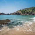 Image showing a serene beach in Gokarna, with crystal-clear waters and cultural landmarks in the background.