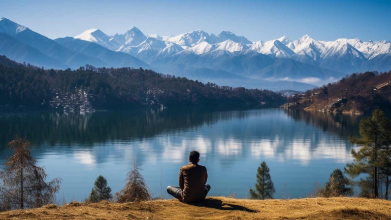 Serene mountain landscape with pine trees and a clear blue sky in Kanatal, Uttarakhand.