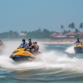 Group of friends enjoying thrilling water sports in Goa, including jet skiing and parasailing.