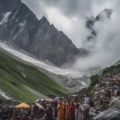 A group of pilgrims trekking towards the sacred Amarnath Cave amidst snow-capped mountains.